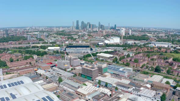 Circling drone shot of Canary Wharf from South London on a sunny day