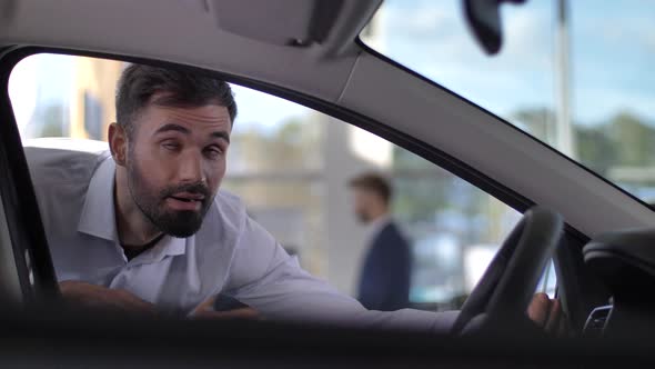 Satisfied Buyer Looking Inside Car at Dealership