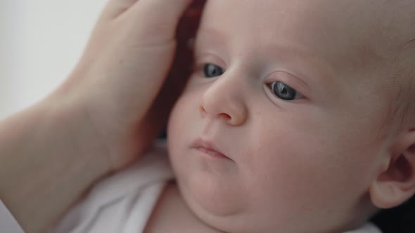 Adorable Newborn Boy Looking at His Mom