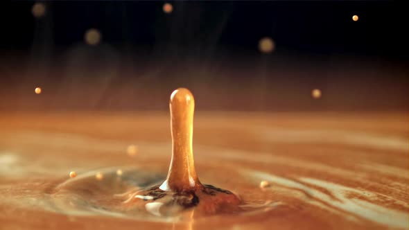 A Drop Falls Into Hot Coffee with Milk