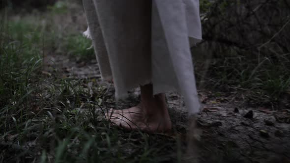 Closeup Slow Motion Of Jesus Christ's Feet Walking In Forest
