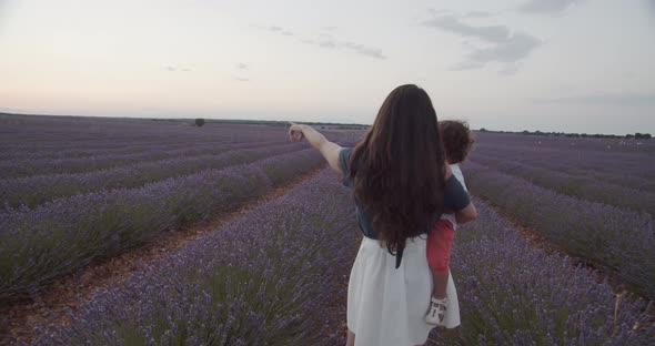 Woman and little child together in lavender field