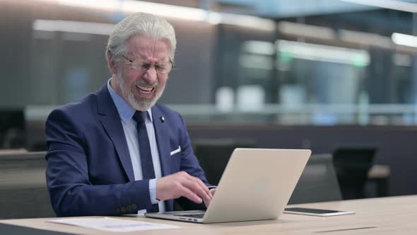 Old Businessman with Laptop Having Neck Pain