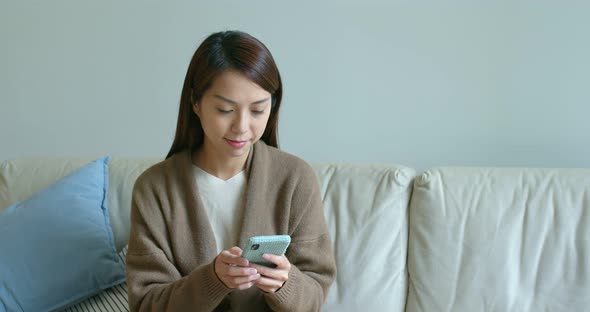 Asian woman use of smart phone at home