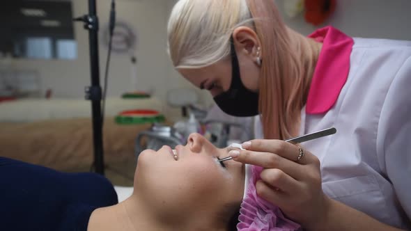 Professional Beautician Undergoing Eyelash Extension Procedure