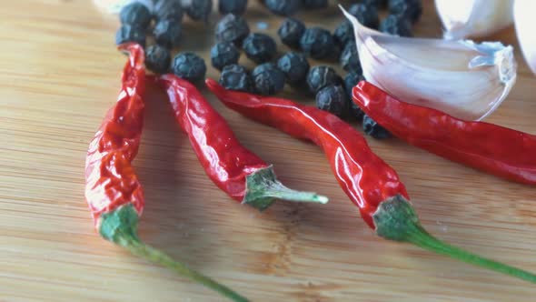 Chillies Pepper and Garlic on a Wood Chopping Board