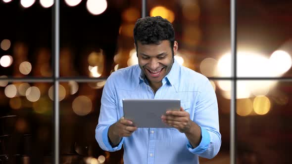 Man Talks Via Tablet Pc with Surprised Expression.