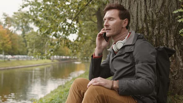 Man Talking on Phone on Lawn