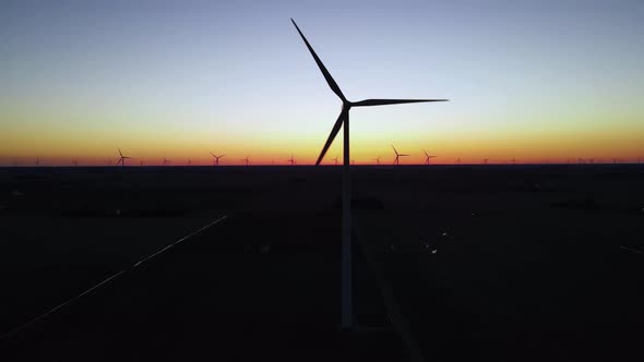 Wind Turbines Blades Silhouettes Spinning in a Twilight