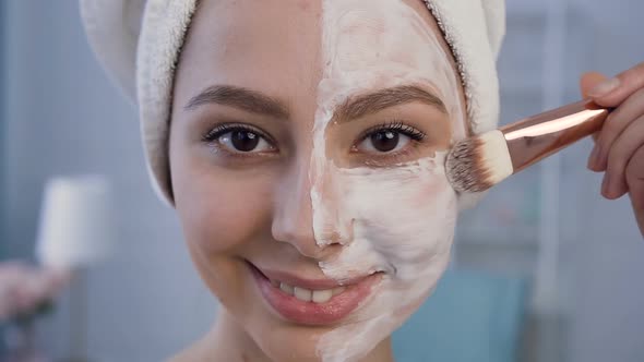 Beautiful Young Woman Applying Mask on the Face.