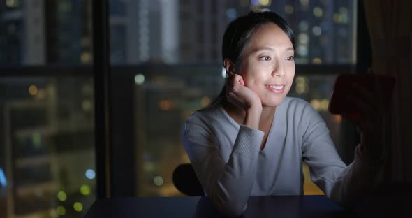 Woman watch on mobile phone at home