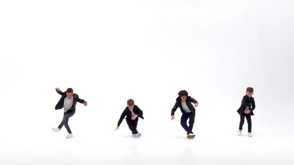 Kids Are Dancing a Modern Dance on the White Background in Black Leather Jackets and Jeans. Slow