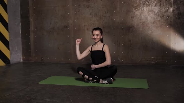 Stretching in the Gym on a Yoga Mat