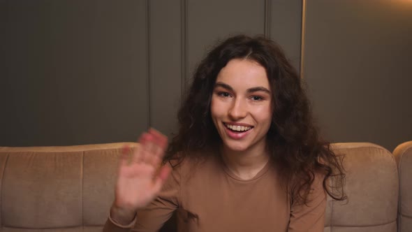 Portrait of Smiling Woman Speaking Looking at Camera Talking Make Video Conference on Couch at Home