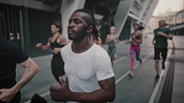 African American Man and His Likeminded Friends Dressed in a Portable Uniform Have a Group Running