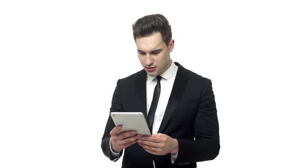 Slow-motion Shocked Businessman with Tablet Computer Reading Bad News or Looking on Revenue Report
