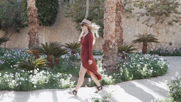 Woman Enjoying Vacation Holidays at Luxurious Hotel Resort Walking to Her Bungalo