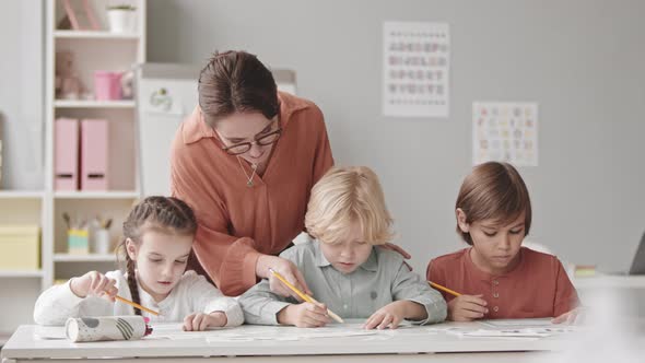 Portrait of Happy Kids and Speech Therapist