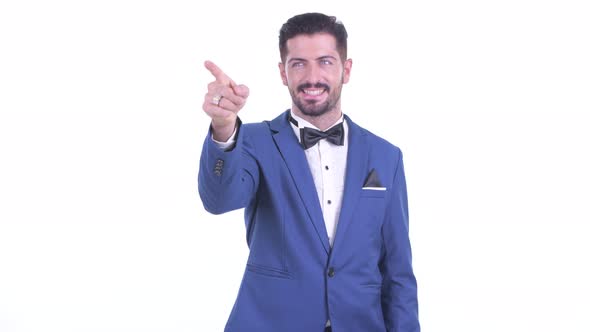 Happy Young Handsome Bearded Businessman Pointing Finger and Directing