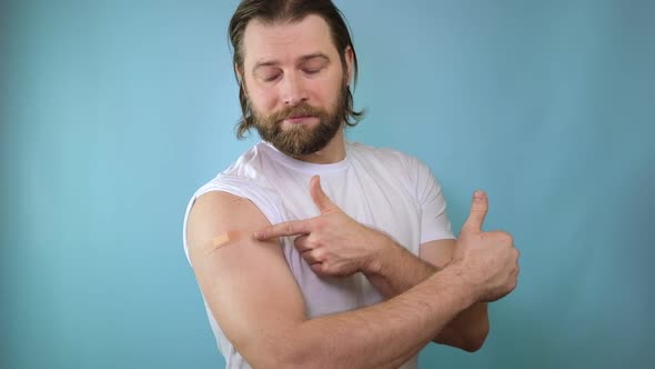 Covid19 Vaccinated Man Gesturing Okay And Showing Arm With Bandage After Vaccine Injection