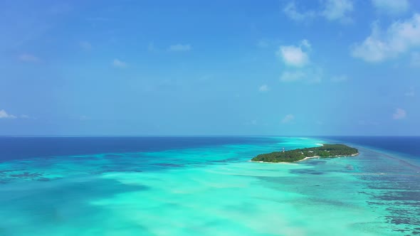 Wide angle birds eye island view of a paradise sunny white sand beach and turquoise sea background