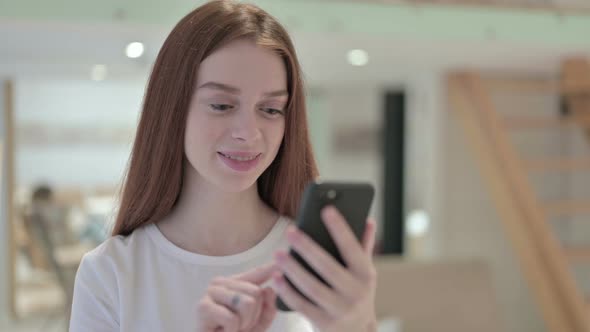 Portrait of Attractive Redhead Young Woman Using Smartphone 