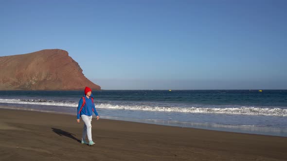 Active Hiker Woman Walks on the Beach