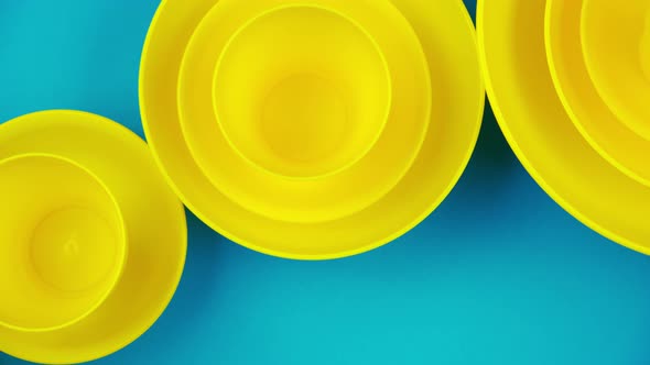 Flat Lay Yellow Cups on a Turquoise Background. Harsh Pastel Colors. Minimalistic Design Style.