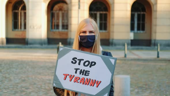 Young Woman Wearing Medical Mask Calling To Stop the Tyranny By Holding Steamer