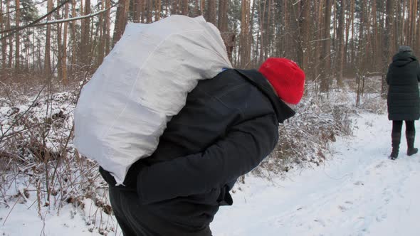 Young Woman and Aged Man with Large White Bag Walk