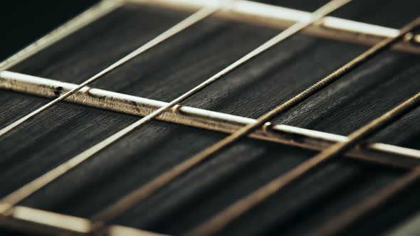 Fretboard details of six-string electric guitar. Worn out, rusty strings closeup