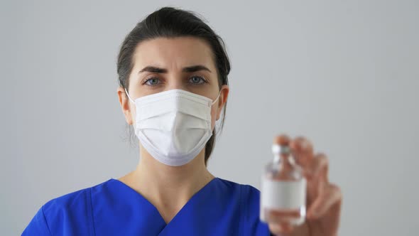 Doctor in Face Mask and Jar of Medicine or Vaccine