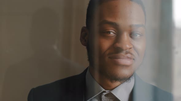 View From Window Through Glass Dreamy Pensive Afro American Business Man Looking to Side Dreaming