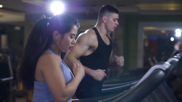 Man and Woman Jogging on a Treadmill