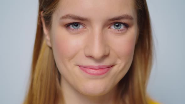 Closeup Smiling Attractive Woman Looking at Camera on Grey Background