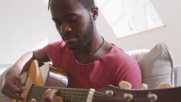 Man playing guitar at home