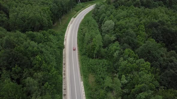 Drone Point of View Tracking Mode Aerial View Flying Over Two Lane Countryside Forest Road with