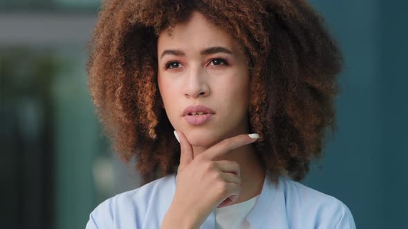 Femsle Portrait Outdoors Afro American Millennial Pensive Girl Puzzled Embarrassed Curly Woman Model
