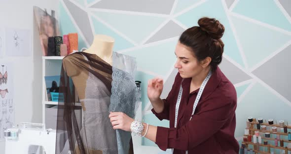 Clothing Designer is Trying New Clothes on Mannequin Fixing It with Needles