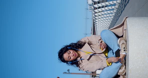 Vertical  Footage of a Young Asian Woman Meditates on the Embankment