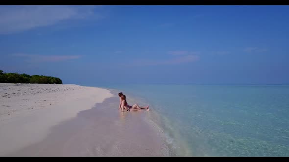 Romantic couple in love on tranquil coastline beach wildlife by turquoise lagoon with white sand bac