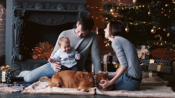 Family with Dog Unpacking Cristmas Gifts at Home