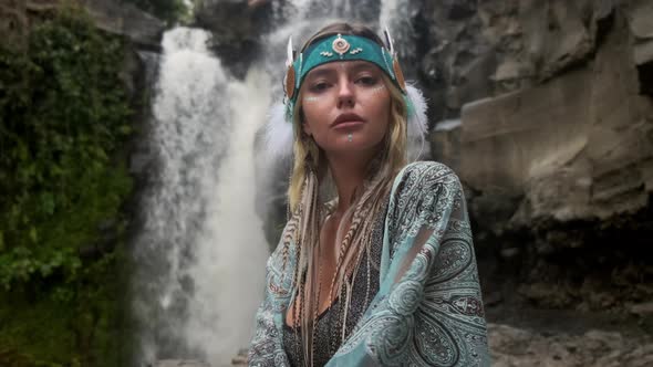 Shamanic and Witch Style of Young Woman in Woodland with Waterfall