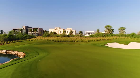 Aerial view of flagstick at golf club on luxury residential area, Dubai, U.A.E.