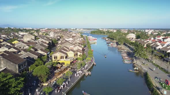 Upper View River with Boats in Town with Crowded Embankment