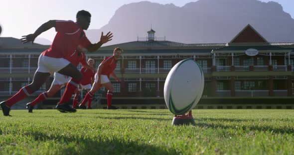 Rugby player kicking the ball from the kicking tee in the stadium 4k