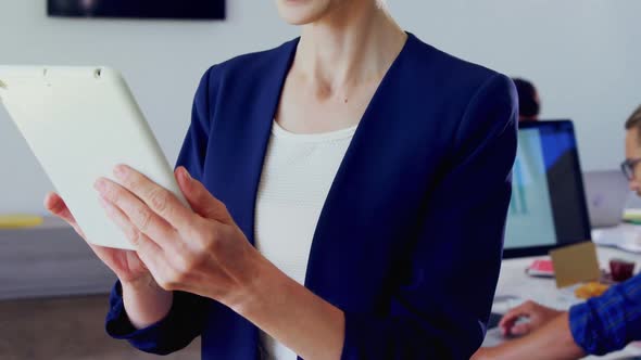 Woman using digital tablet in office