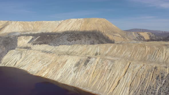 Open mining pit pyrite and red drainage waters 4K drone video