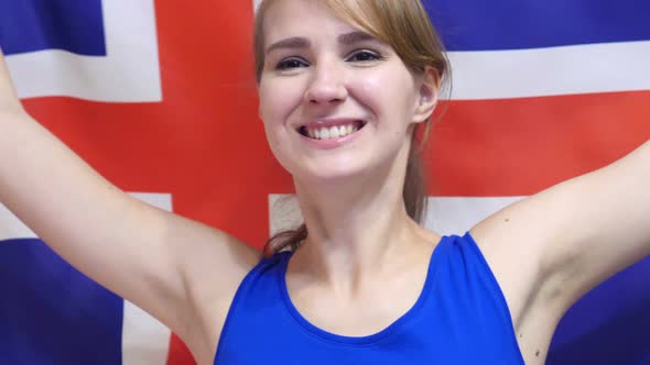 Icelandic Young Woman Celebrating while Holding the Flag of Iceland