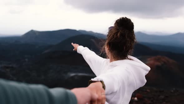 Young Couple Holding Hands Woman Leading Boyfriend Shows View of Volcanoes